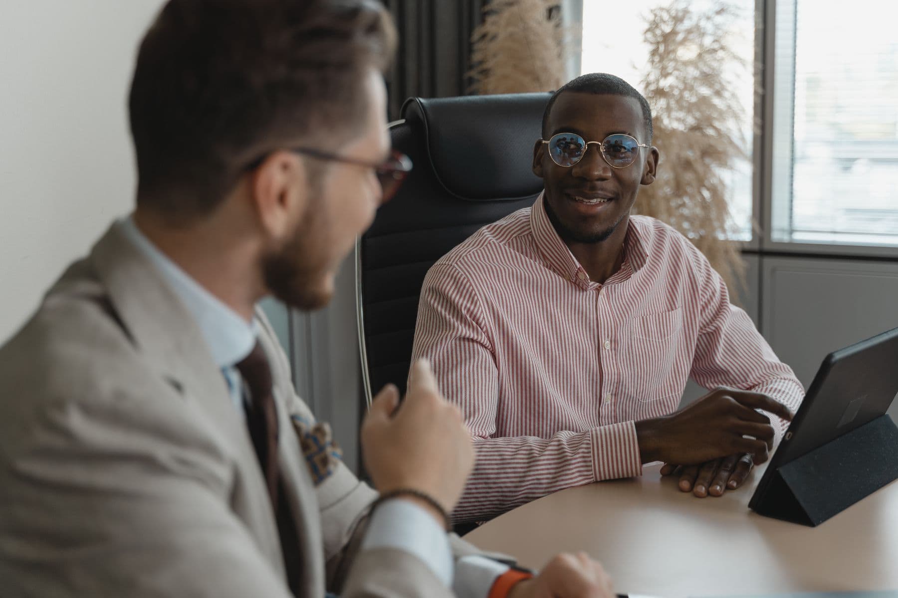 Professionals having a focused conversation in a bright workspace