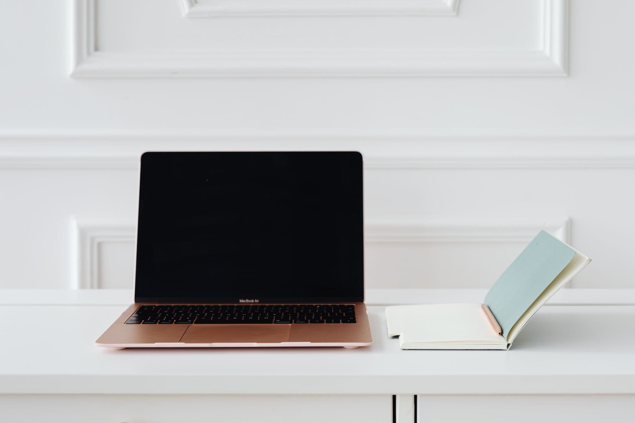 A real workspace with a laptop and notebook, ready for a focused job search
